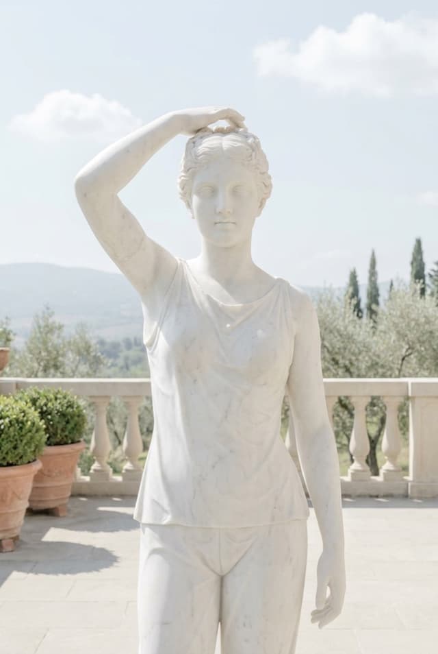 Marble pose card showing an upper-body selfie with one hand in the hair